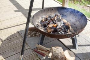a grill with a bunch of mushrooms cooking on it at Hawkings Hideaway in Knowstone