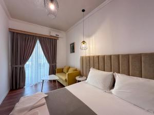 Postel nebo postele na pokoji v ubytování Hotel Murati