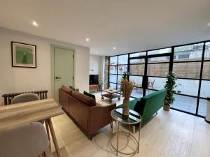 a living room with a couch and a table at Hackney 1 Bed Garden Flat in London