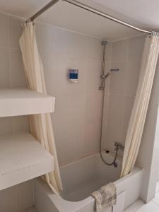 a shower in a bathroom with a shower curtain at TERPSICHORE Holiday Apts in Limassol