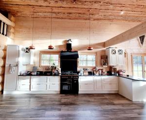 a kitchen with white cabinets and a black stove at EddyLou Ranch in Slöinge