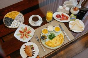 a table topped with plates of breakfast foods and drinks at Like INN Hotel in Samarkand