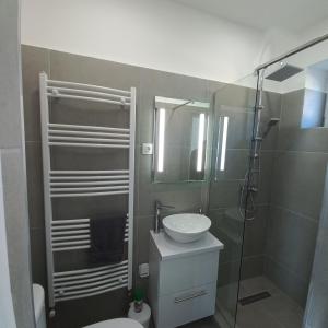 a bathroom with a toilet and a sink and a shower at Stílus Apartman in Vásárosnamény