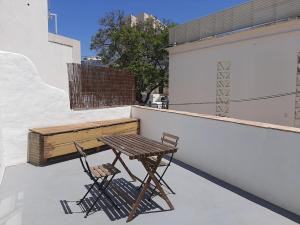 a wooden table and two chairs on a balcony at Traditional House in Historical Center of Faro in Faro