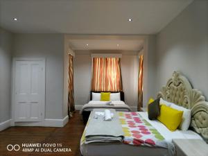 a bedroom with two beds and a window at HEBA GUEST LODGE in Uitenhage