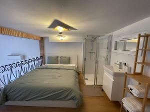 a bedroom with a large bed and a shower at St Catherine in Liège