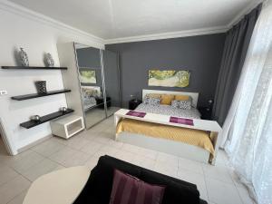 a bedroom with a bed and a couch at Location Location Location in Sliema