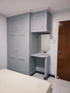 a room with a bed and a wall with a shelf at Sunrise Beach Residences u2 in Olongapo +8 photos
