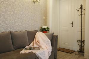 una coperta sul retro di un divano in soggiorno di Apartament pałacowy a Świebodzin