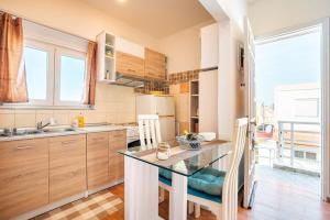 a kitchen with a table and a counter top at Ciel Rhodes in Rhodes Town
