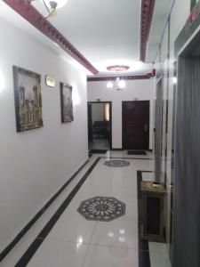 pasillo con paredes blancas y suelo de baldosa en أجنحة أبو قبع الفندقيةAbu Quboh Hotel Suite Apartment en Amán