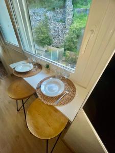 a table with two chairs and a large window at STUDIO LA PINTA CASSIS in Cassis