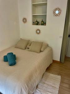 a bedroom with a large bed with two pillows at STUDIO LA PINTA CASSIS in Cassis