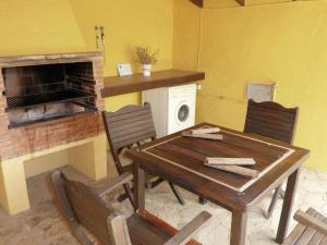 a dining room with a table and a fireplace at Belvilla by OYO Finca las Chozas in La Joya
