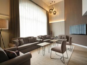 a living room with a couch and a tv at Luisenhof by Bütgenbacher-Hof in Butgenbach