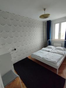 a small bedroom with a bed and a window at Warszawa Apartament z Widokiem in Warsaw