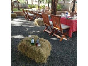 a group of chairs and a table with hay bales at Kivulini Eco Park in Nairobi