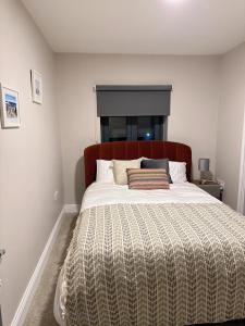 ein Schlafzimmer mit einem großen Bett mit einer Decke in der Unterkunft Dallkey Retreat in Dalkey