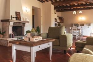 a living room with a table and a fireplace at Wine Estate Rooms Paradiso di Cacuci in Montalcino