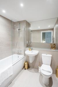 a white bathroom with a toilet and a sink at Lovely 1-Bed Apartment in London in London