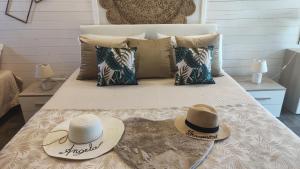 two hats sitting on top of a bed at La Fattoria Dei Nonni in Paterno