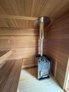 a inside of a sauna with a stove in it at Kenttäpirtti in Kittilä