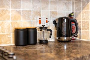 a kitchen counter with a coffee maker on a counter top at Stylish 1-Bed Flat in Bristol in Bristol