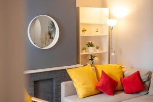 a living room with a couch with yellow and red pillows at Stylish 1-Bed Flat in Bristol in Bristol