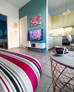 a living room with a couch and a tv at CityZEN View - Retro Nest in Argostoli +16 photos