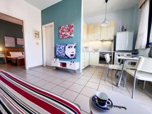 a kitchen and living room with a tv and a table at CityZEN Apartment with a View in Argostoli
