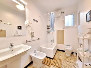 uma casa de banho branca com um lavatório e um WC em apartament Eliette 4 em Bagá