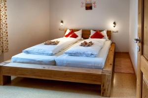 two beds in a room with two dogs laying on them at Granerhof Ferien in Peißenberg