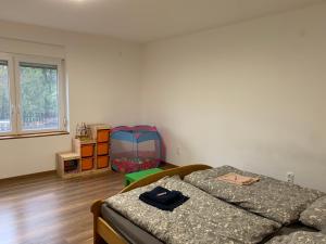 a bedroom with two beds and a window at Sárdoár Vendégház in Abádszalók