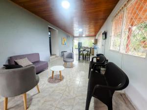 een woonkamer met een bank, stoelen en een tafel bij Llanitos de Aurora in Ibagué