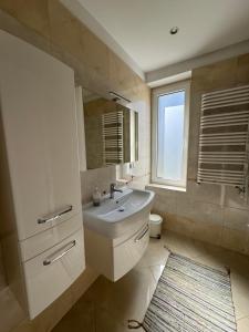 a bathroom with a sink and a mirror and a window at Myśliwska 23 - Cały dom na wyłączność in Szczyrk +28 photos