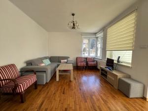 a living room with a couch and a table at Myśliwska 23 - Cały dom na wyłączność in Szczyrk