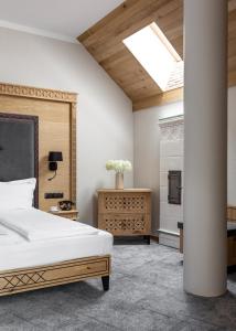 a bedroom with a bed and a skylight at Aparthotel Cristina in Zakopane