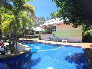 a swimming pool in front of a building at Lemon House in Patong Beach