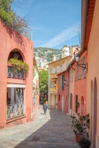a person walking down a street in an alley at Cosy flat in the heart of Villefranche-sur-Mer in Villefranche-sur-Mer
