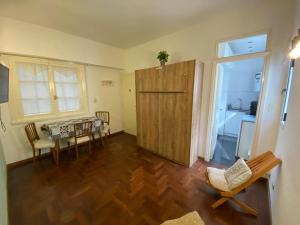 a living room with a table and chairs and a kitchen at Departamento Mar del Plata in Mar del Plata