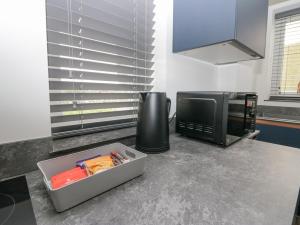 a kitchen with a microwave and a counter top at Driftwood Studio in Ulverston