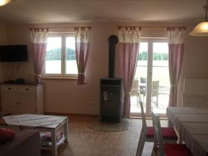 a living room with a fireplace and a table at Granerhof Ferien in Peißenberg