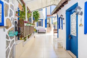 a street in positano in the amalfi coast with blue doors at MERVE BUTİK OTEL in Didim +125 photos