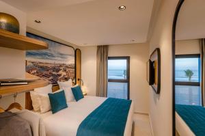 a hotel room with a bed and a large window at MIA Mazagan Bay in El Jadida