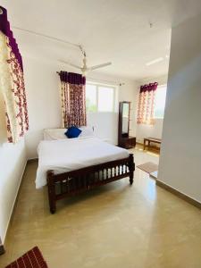 a bedroom with a bed in a room at Misty Green Coorg in Madikeri