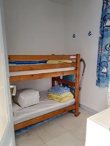a couple of bunk beds in a room at Villa centre-ville proche plage -6264 in Soulac-sur-Mer