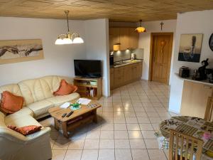 a living room with a couch and a table at Uschi's Familienparadies in Monschau +13 photos