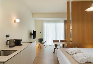 a kitchen and living room with a bed and a table at Alinea Market Agora Square in Limassol +14 photos
