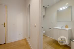 a white bathroom with a toilet and a sink at Comodo y centrico Loft en calle Carretas - Madrid Centro in Madrid +22 photos