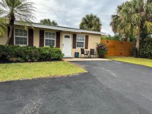a house with a driveway in front of it at Cozy 2 bedroom near intercoastal & beaches in North Palm Beach
